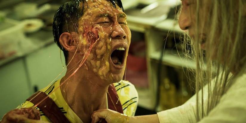 A man with boils on his face scream in pain in The Sadness