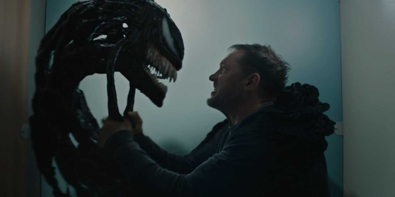 Eddie Brock, played by Tom Hardy, sternly speaks to the head of Venom in 'Venom: Let There Be Carnage'.