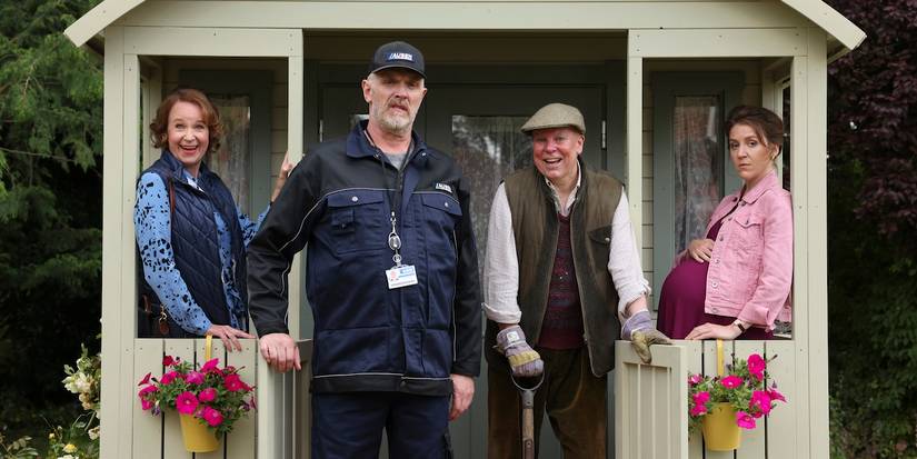 Greg Davies and the cast of The Cleaner Season 3 pose near a shed and look towards the camera