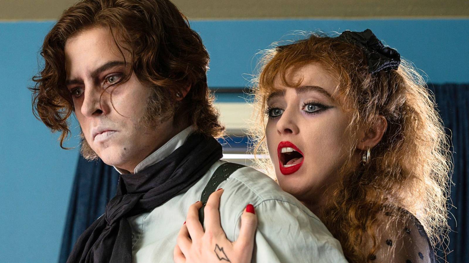 Cole Sprouse standing in front of Kathryn Newton who is clinging to him in Lisa Frankenstein (2024).