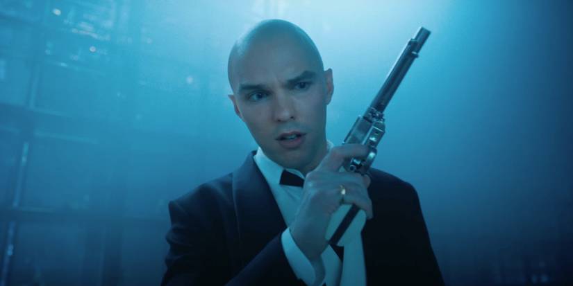 Nicholas Hoult as Lex Luthor holding a gun in Superman 