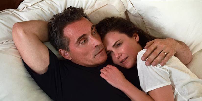 Hal and Kate holding each other in bed on The Diplomat.