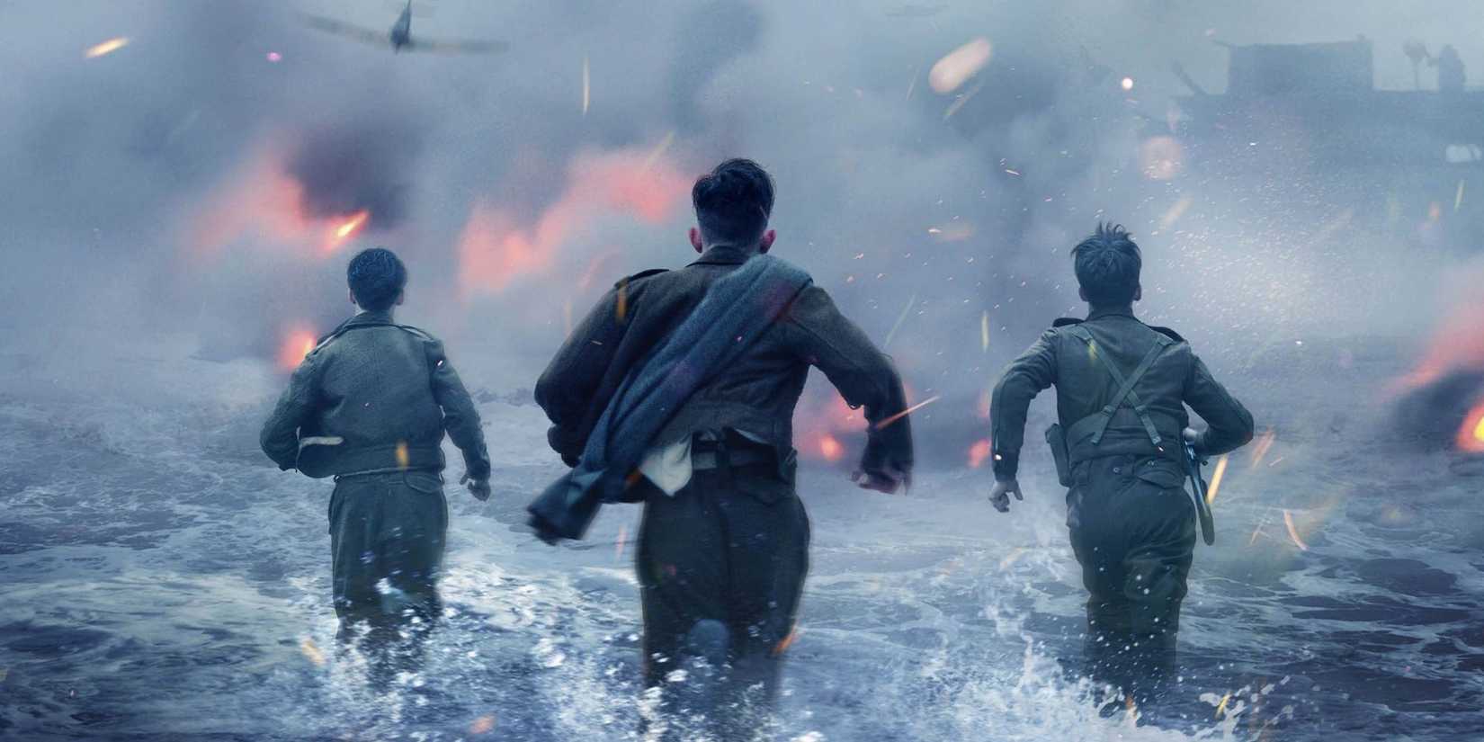 Three soldiers running in the water in Dunkirk.
