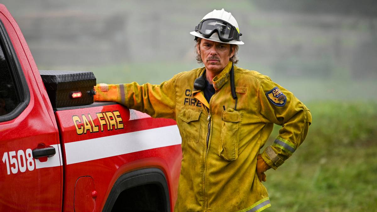Billy Burke standing next to a Cal Fire truck