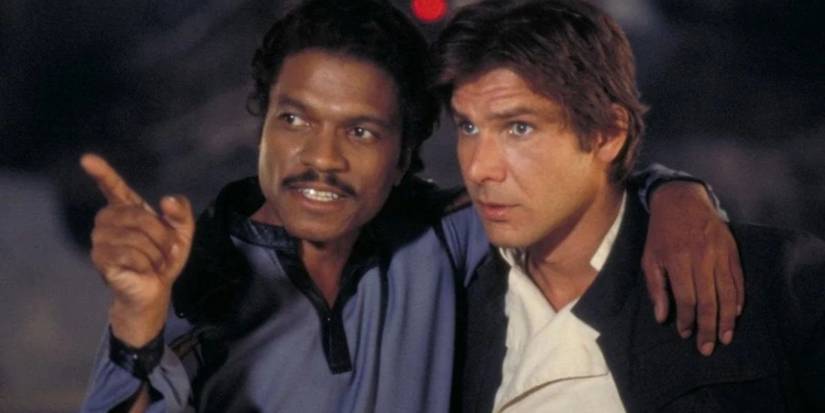 Harrison Ford as Han talks to Billy Dee Williams as Lando, who points ahead in The Empire Strikes Back.