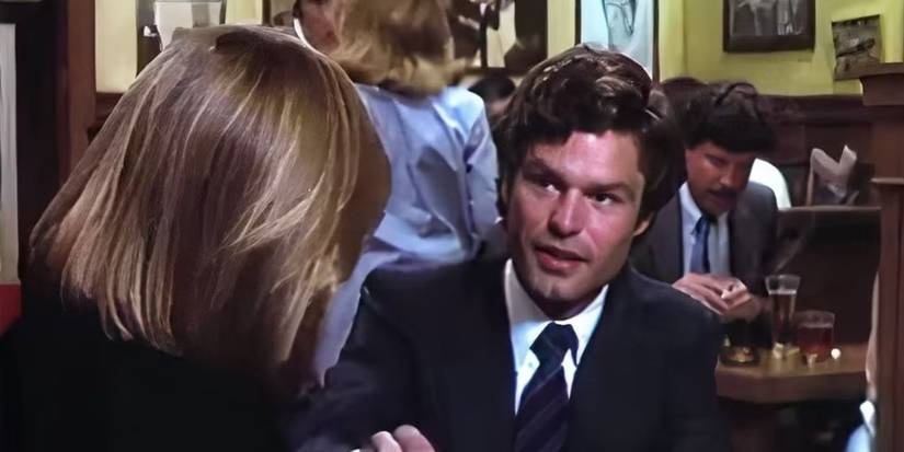 Susan Dey as Grace Van Owen shakes hands with Harry Hamlin as Michael Kuzak in a restaurant in L.A. Law.