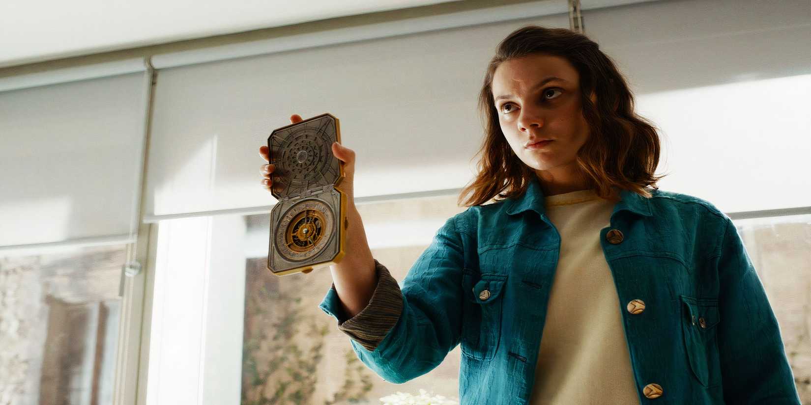 Lyra holding the compass in His Dark Materials.