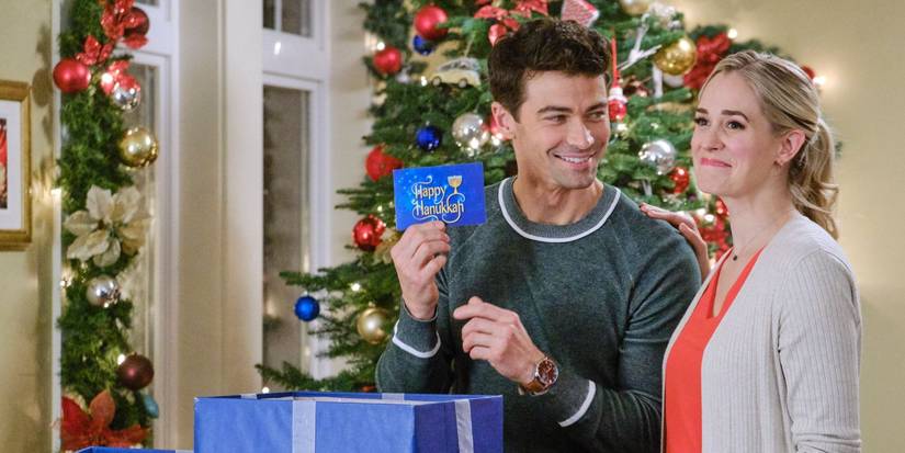 Brooke and Joel looking very happy opening a present in Holiday Date.