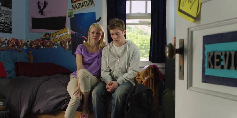 Jeremy Allen White and Naomi Watts sitting on a bed and talking in Movie 43