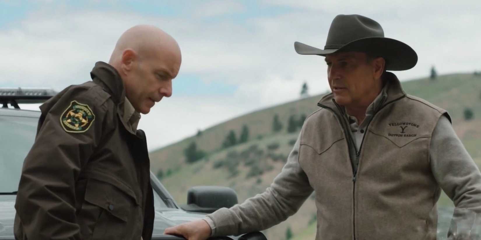 John (Kevin Costner) and Sheriff Haskell (Hugh Dillon) talk beside a car in Yellowstone's Season 2 finale.