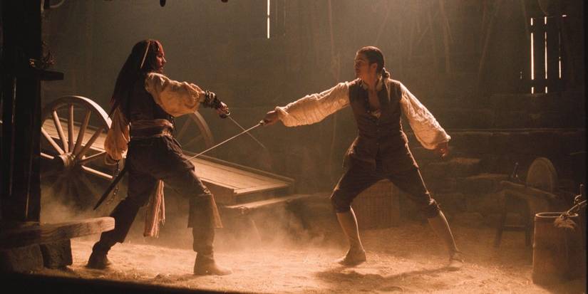 Jack Sparrow and Will Turner cross swords in Pirates of the Caribbean the Curse of the Black Pearl.