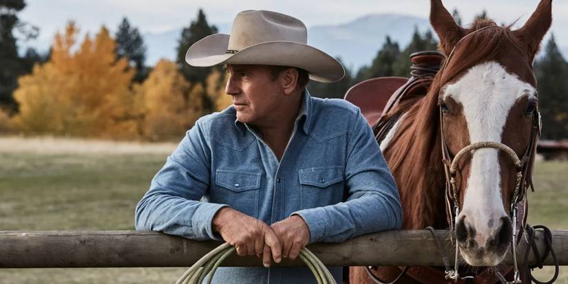 Kevin Costner as John Dutton posing with a horse in the first episode of Yellowstone.