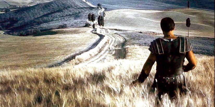 Russell Crowe as Maximus walking through a wheat field, touching the wheat, in 'Gladiator'