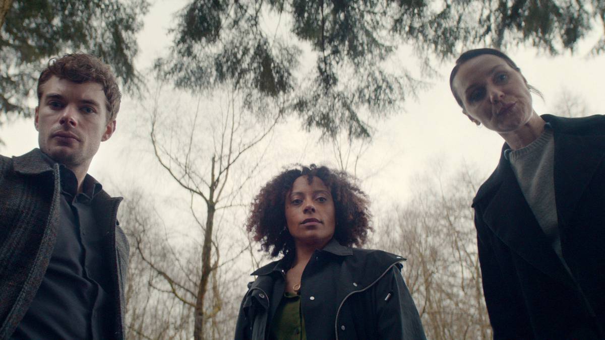 Rosalind Eleazar, Charlie Hamblett, and Catherine Ayers looking down at something in Missing You.