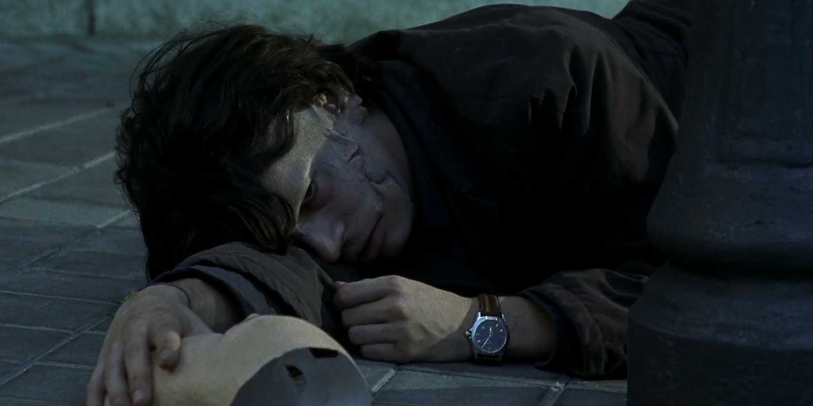 Disfigured Eduardo Noriega lying on the ground holding a mask in Alejandro Amenabar’s Open Your Eyes
