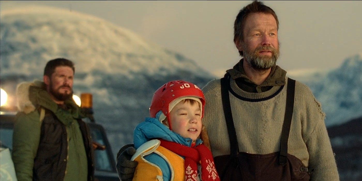Rauno (Jorma Tommila) with an arm around the shoulders of his son Pietari (Onni Tommila) in the sunrise with Aimo (Tommi Korpela) standing behind them in "Rare Exports"