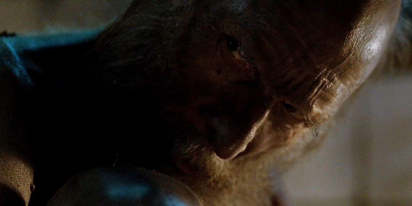 An old, naked man sitting with his knees pulled up to his chest and looking evilly over his shoulder in "Rare Exports"