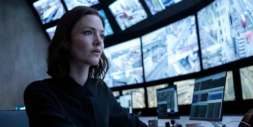 Holliday Grainer as Rachel Carey sitting in front of CCTV monitors in 'The Capture'