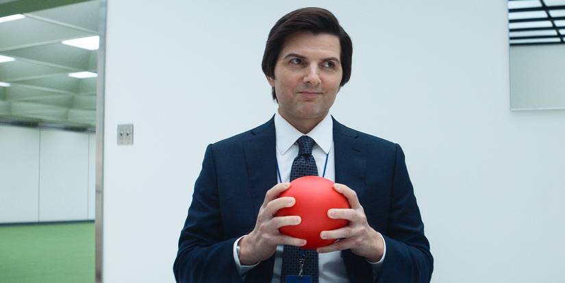 Mark (Adam Scott) smiling and holding a red ball in Severance Season 2.
