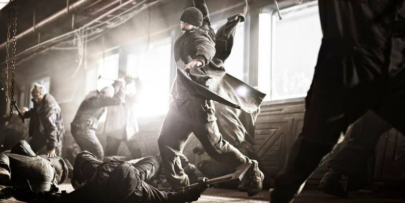 Curtis (Chris Evans) swinging a weapon at someone in Snowpiercer