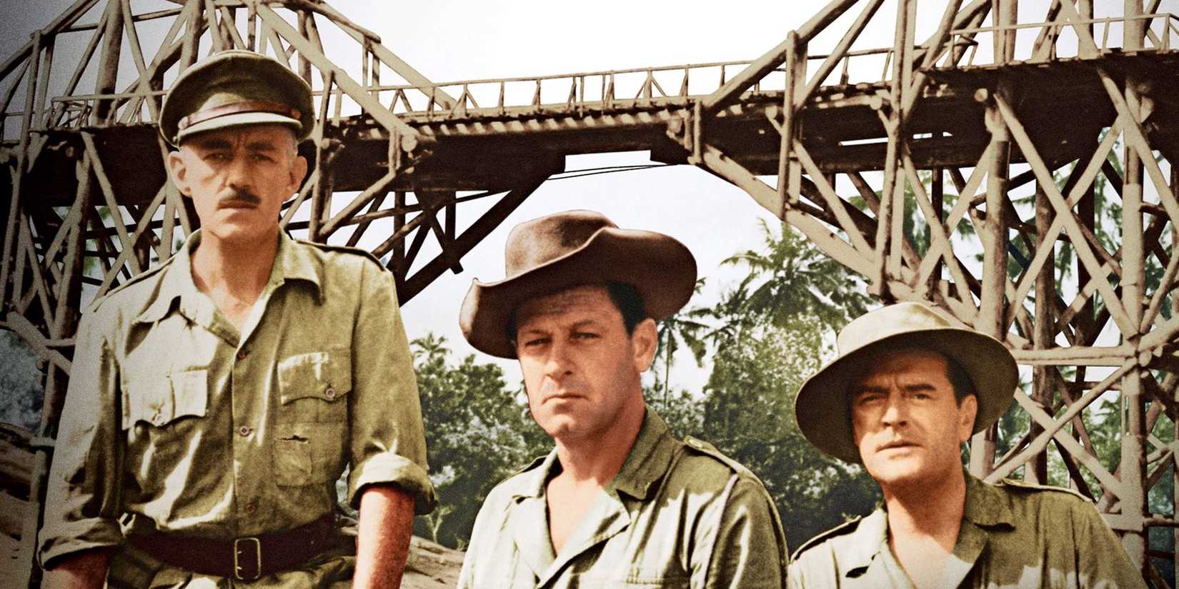 Three soldiers in front of the titular bridge in The Bridge on the River Kwai.