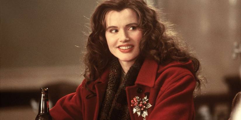 Geena Davis as Samantha Caine wearing a red winter coat with a Christmas brooch in The Long Kiss Goodnight