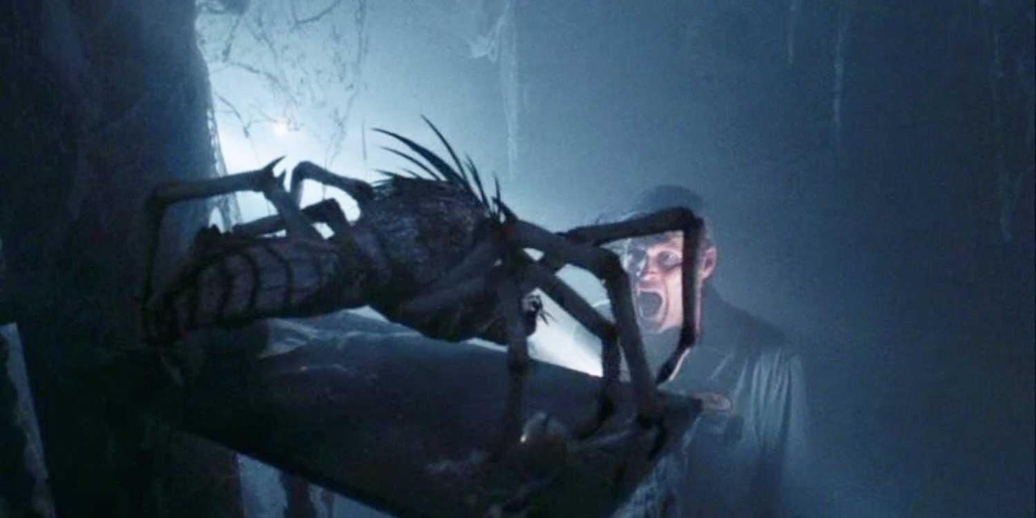 A man screaming at a small, spider-like monster in The Mist