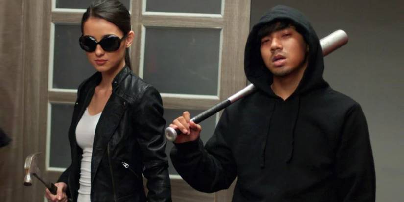 Julie Estelle as Alicia holding a hammer and Very Tri Yulisman as Baseball Bat Man, holding a baseball bat, in The Raid 2