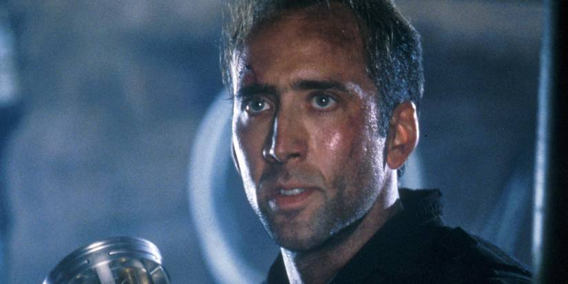 Nicolas Cage as Stanley Goodspeed holding the bioweapon in The Rock