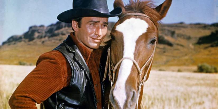 James Drury as The Virginian alongside his horse on 'The Virginian'