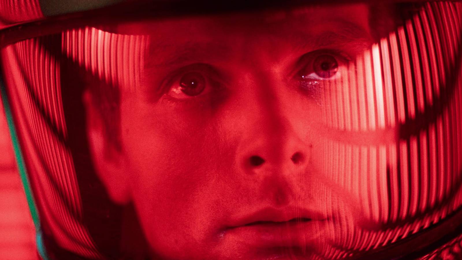 An astronaut under a red light looking ahead in 2001- A Space Odyssey. 