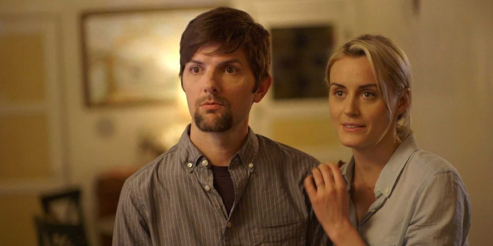 Alex (Adam Scott) and Emily (Taylor Schilling) looking surprised in 'The Overnight'