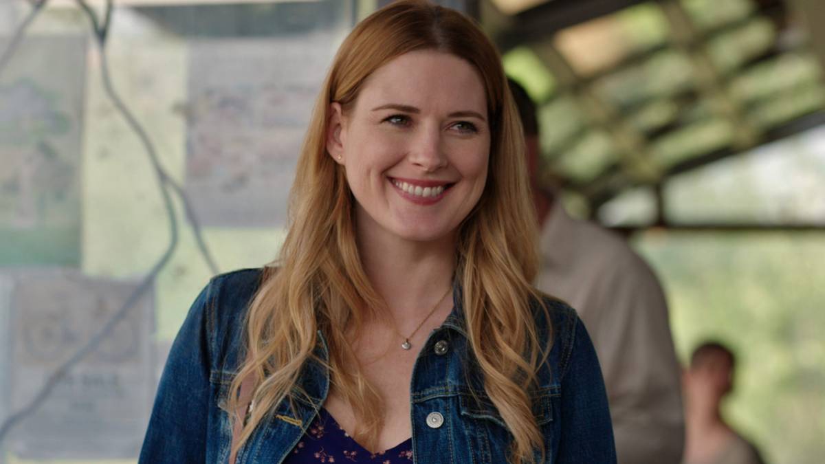 Alexandra Breckenridge as Mel Monroe smiling widely and looking at someone off-screen in Virgin River.