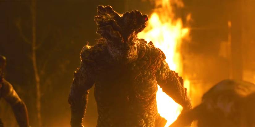 bloater-with-other-infected-and-fire-in-background
