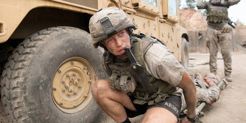 Carter (Caleb Landry Jones) crouching down in 'The Outpost'