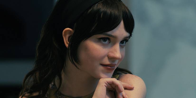 Iris (Sophie Thatcher) smiling to someone off-camera in Companion.