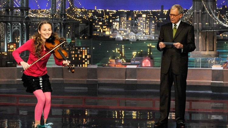 David Letterman introduces a girl playing violin on "Stupid Human Tricks" on Late Show with David Letterman