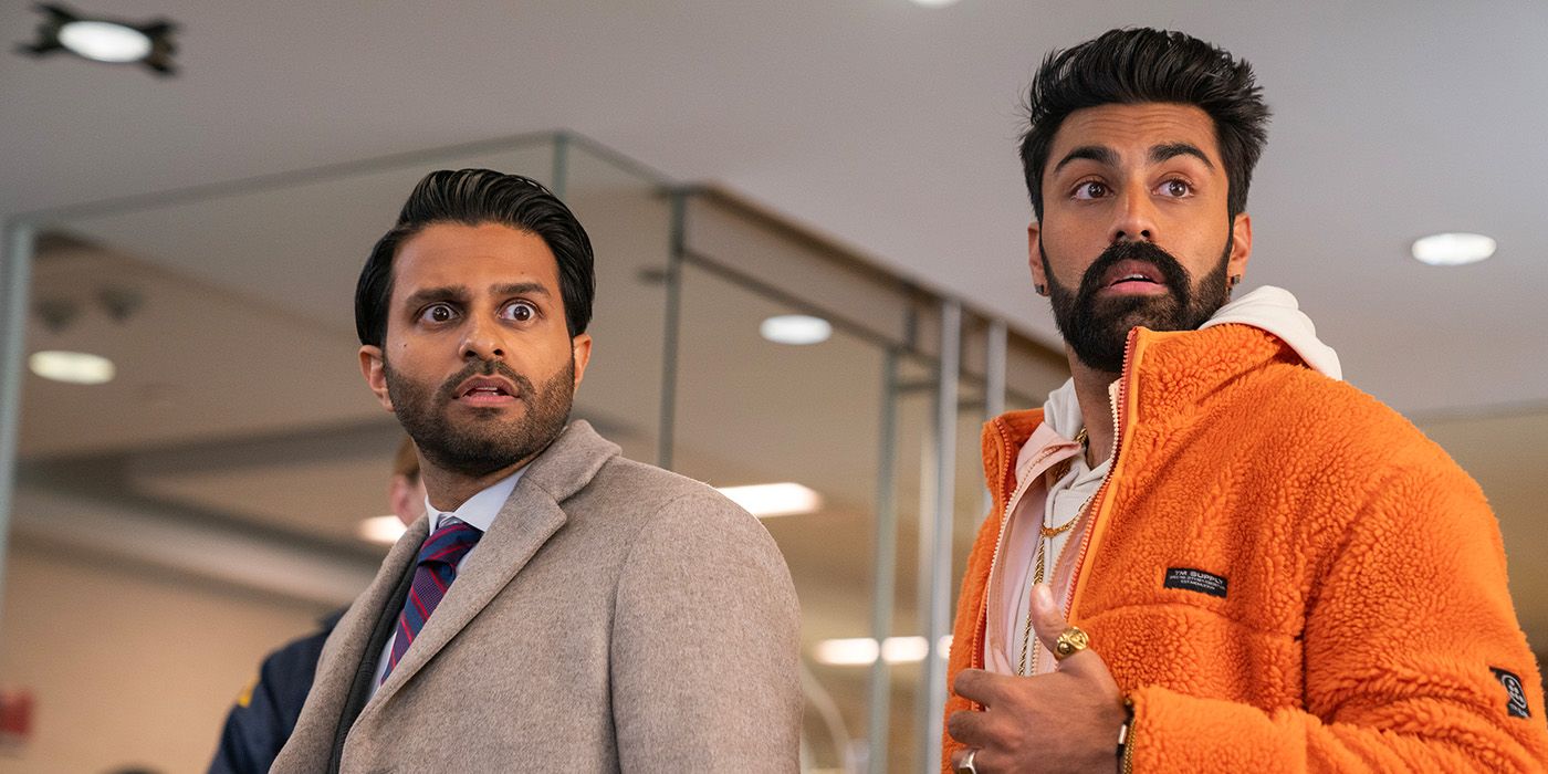 Mir and Raj looking surprised as the FBI raid their father's office in a scene from Deli Boys Season 1.
