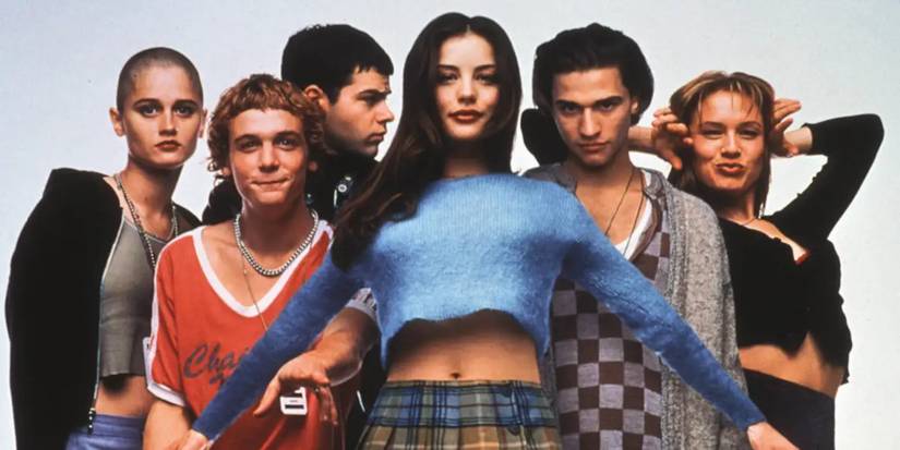 The cast of Empire Records pose for a promotional photo in front of a plain white backdrop.