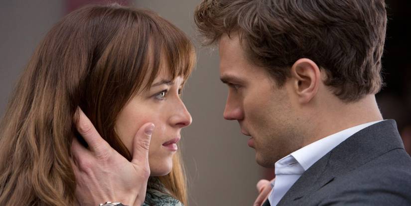 Dakota Johnson and Jamie Dornan starign into each other's eyes in Fifty Shades of Grey 