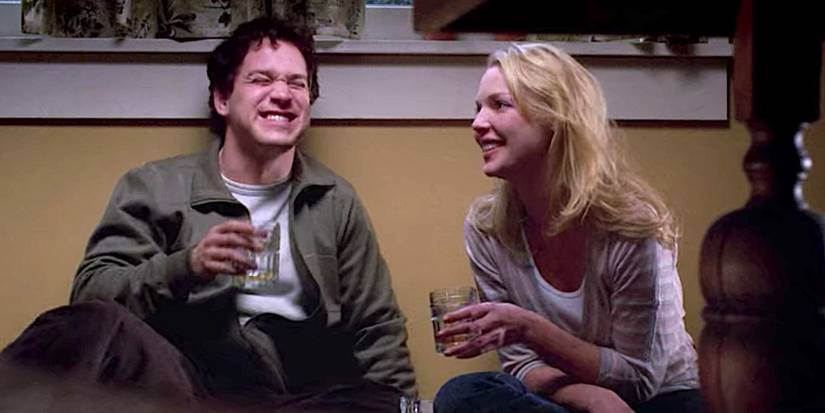 George O'Malley (T.R. Knight) and Izzie Stevens (Katherine Heigl) drinking and laughing in 'Grey's Anatomy'.