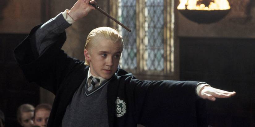Draco Malfoy raising his wand