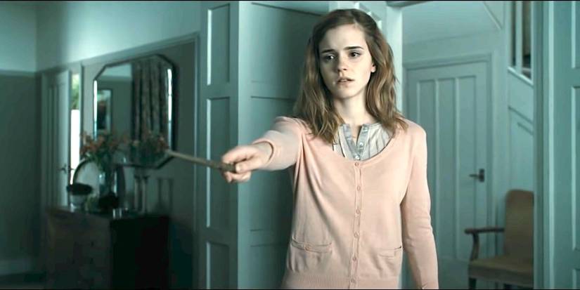 Emma Watson as Hermione looks sad, performing Obliviate in Harry Potter and the Deathly Hallows: Part 1.