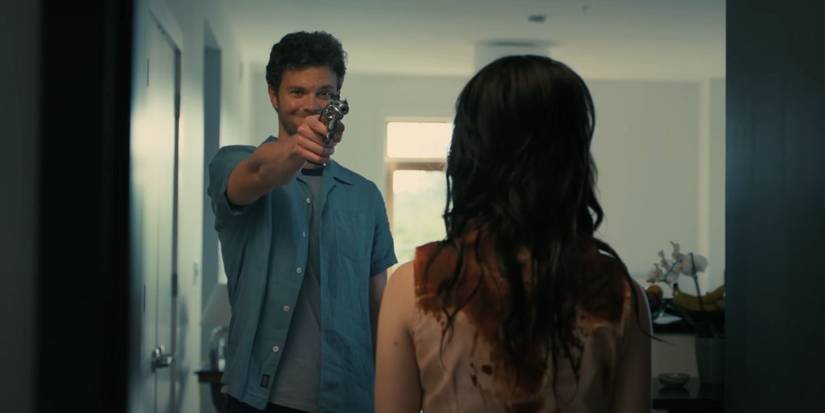 Jack Quaid as Josh pointing a gun at Sophie Thatcher's Iris in Companion.