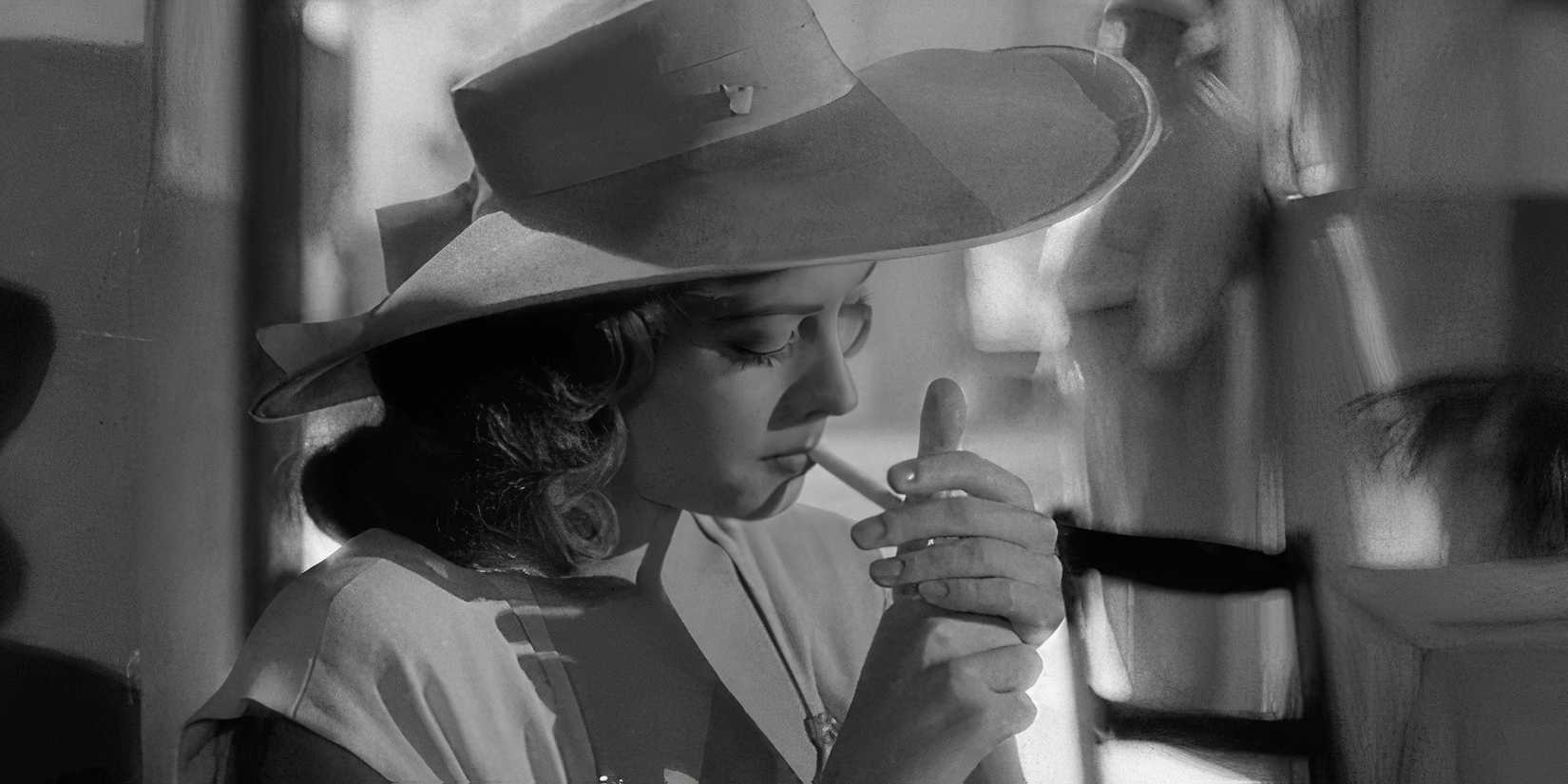 Jane Greer as Kathie Moffat in Out of the Past smoking a cigarette