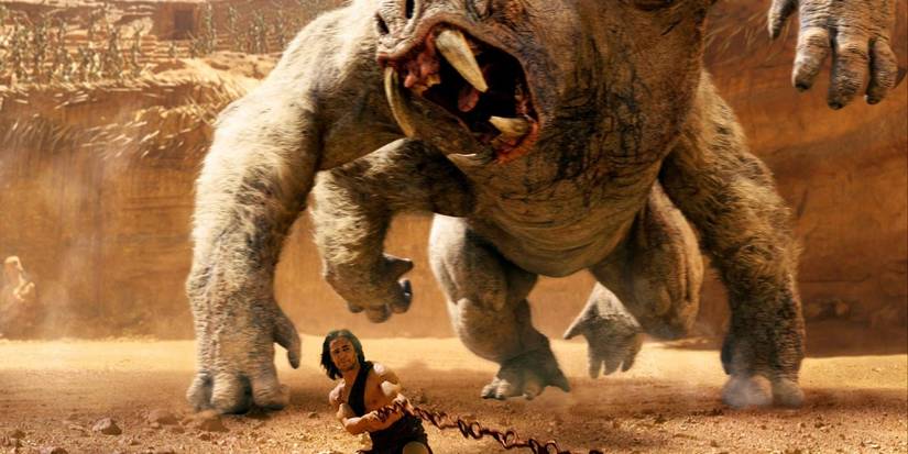 John Carter runing from a monster at a Coliseum