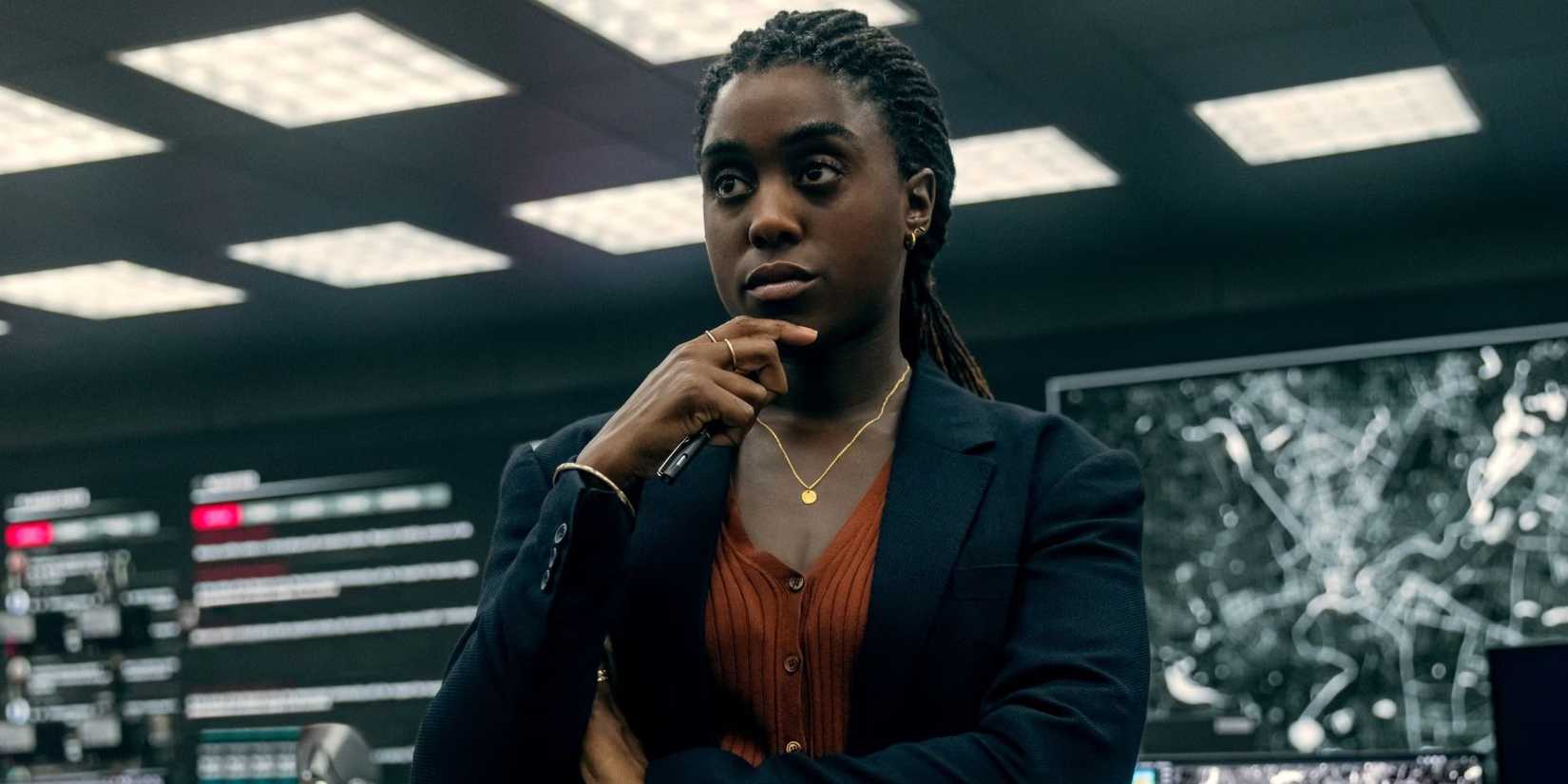 Lashana Lynch as Bianca Pullman resting her hand on her chin, looking at monitors in The Day of the Jackal.