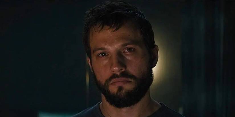Logan Marshall-Green looking at the camera with an empty expression in Upgrade