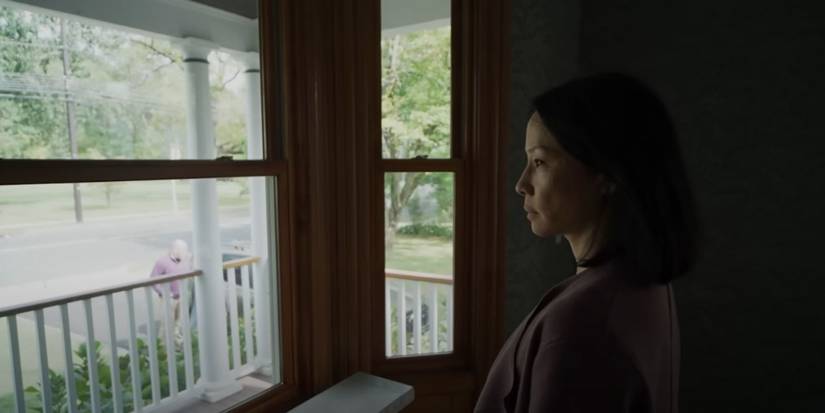 Lucy Liu as Rebecca looking out a window in 'Presence'.
