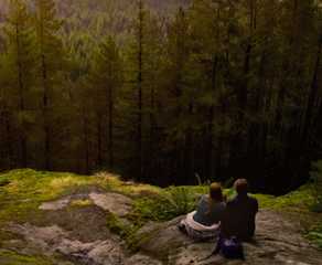 Mel and Jack sitting in the woods after a hike in 'Virgin River'.
